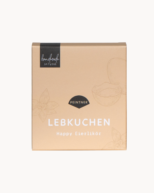 Lebkuchen: hellgelbe Verpackung mit Vanille und Ei Zeichnungen und der Aufschrift „Lebkuchen Happy Eierlikör“ von Peintner, handmade in Tyrol.